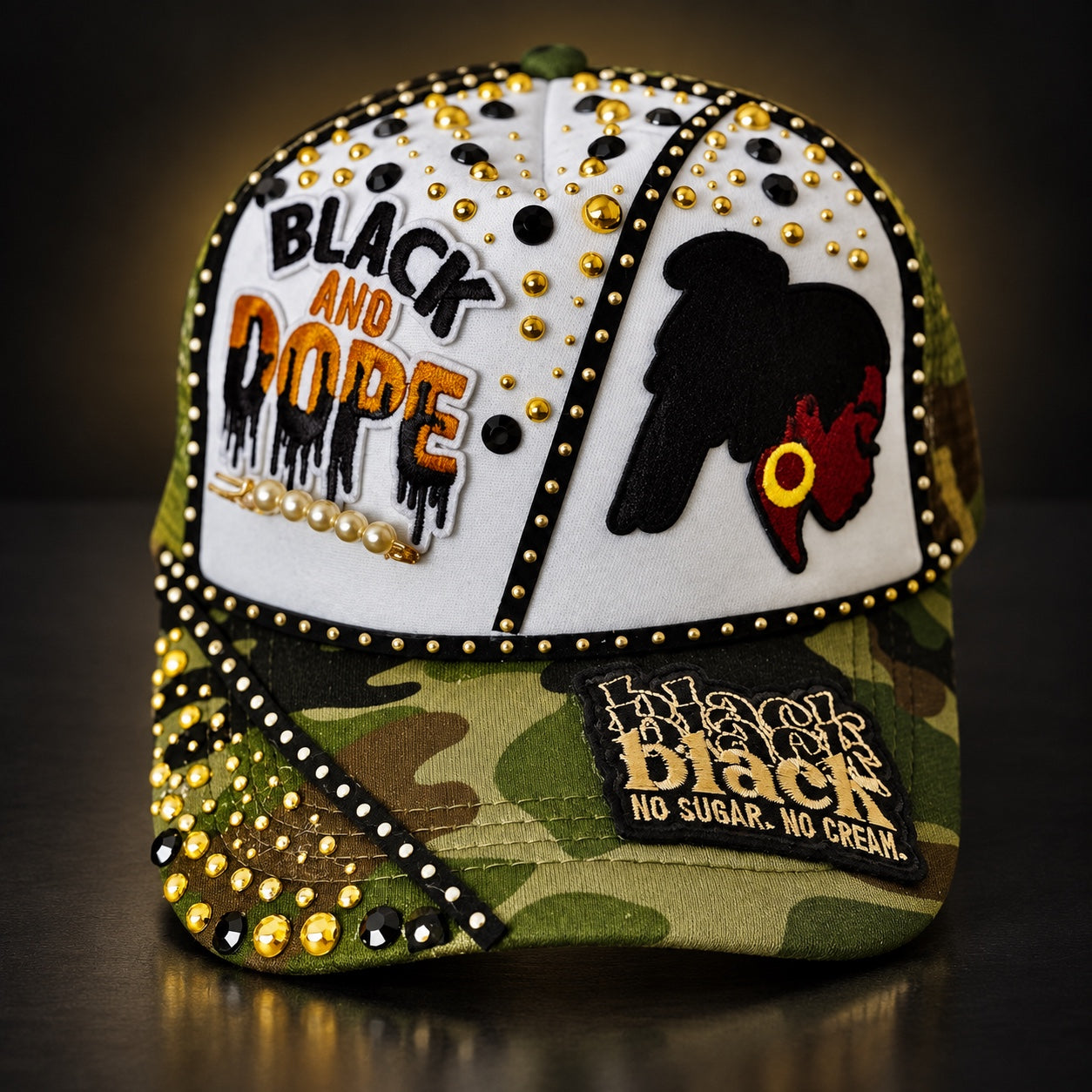 Camo and white Black and Dope statement cap with black and gold embellishments, rhinestones, pearls, and Black woman silhouette