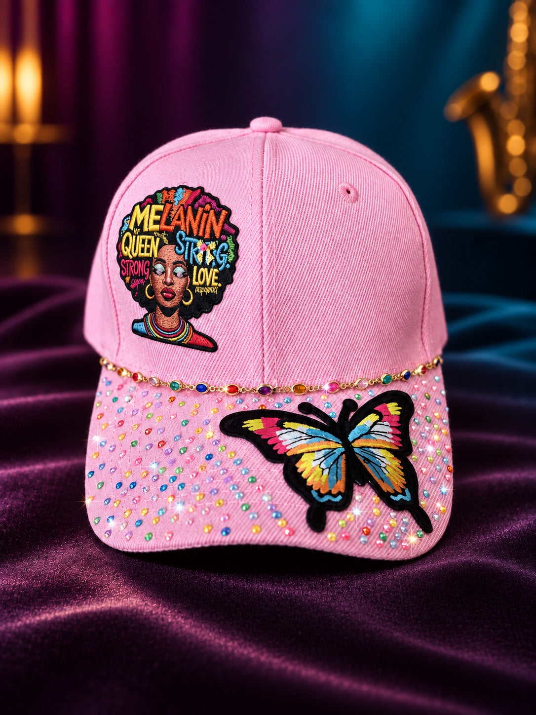 Pink Melanin Queen statement cap with colorful rhinestones, butterfly applique, and multicolor accents