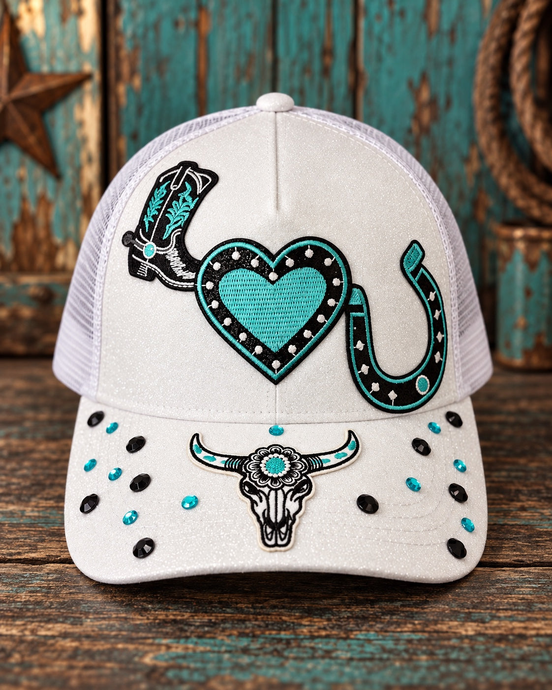 White trucker cap with turquoise and black Western patches and decorative stones